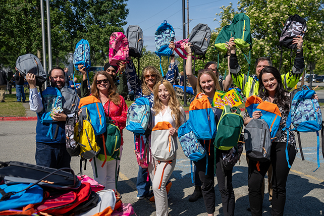 Alaska Communications team filling backpacks helping of our partners at the Boys & Girls Clubs and the Zach Gordon Youth Center