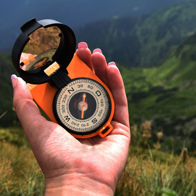 Our Goals as depicted by a hand-held compass, demonstrating direction