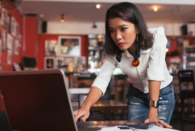 Business owner checking email with unlimited business internet