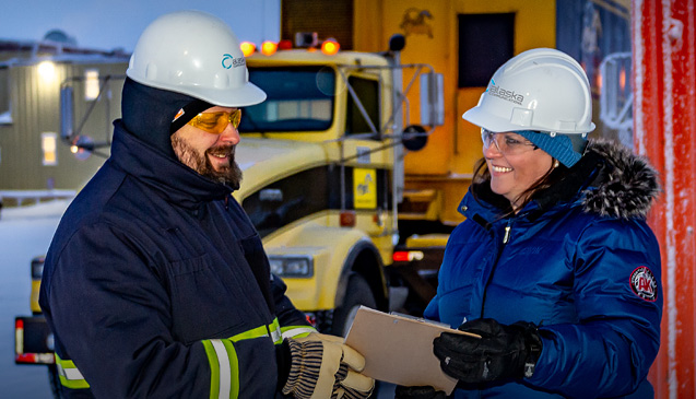Alaska Communications workers in winter outdoor industrial setting