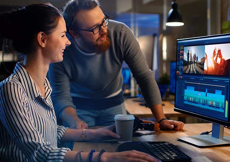 working professionals gathered at a workstation