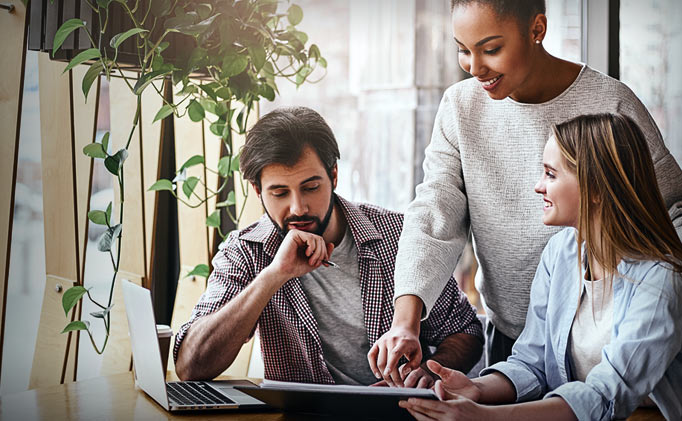Small business colleagues discuss company financial statistics at office briefing